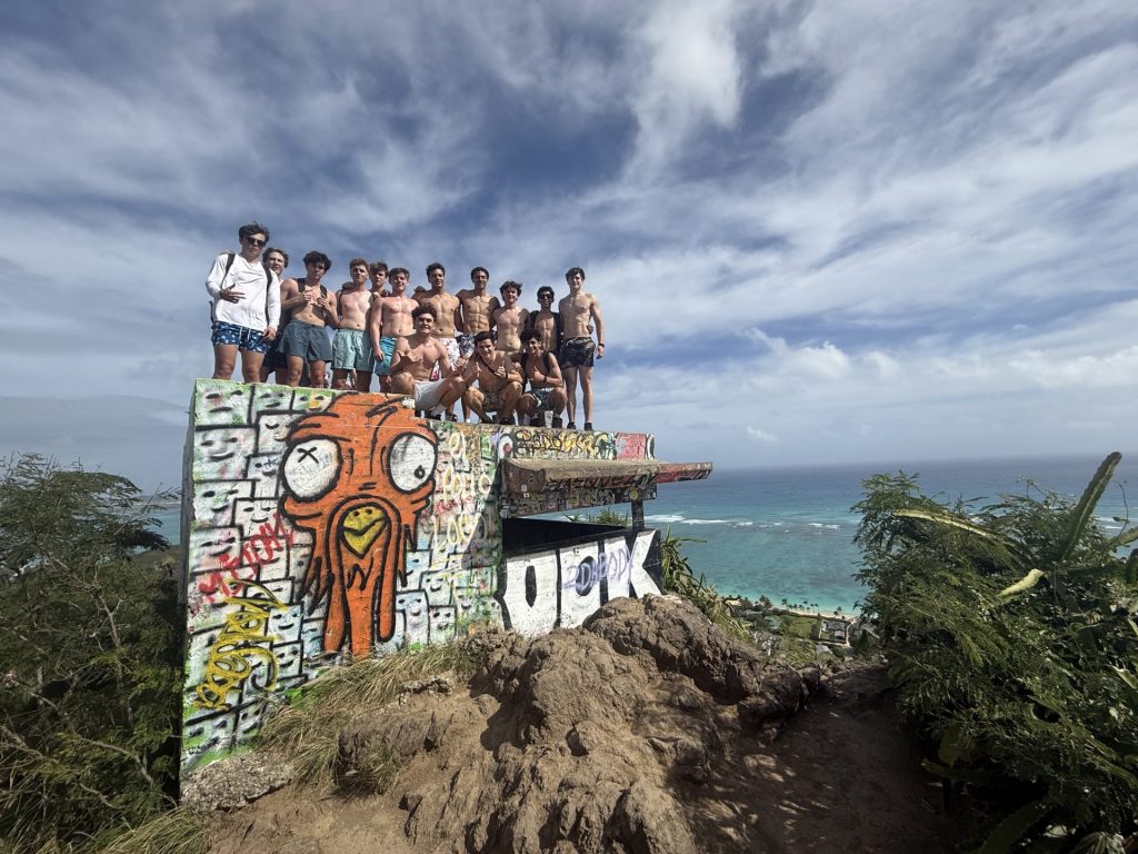 Brotherhood and Honor in Hawai‘i | Eighteen students from Brophy’s Veterans Advocacy Club and Hope Squad participated in Brophy’s inaugural immersion trip to O‘ahu, a journey that bridged history and service. The experience began at home with the Imprints of Honor project, where students interviewed veterans to document their stories of sacrifice. Once in Hawai‘i, the group visited Pearl Harbor and the USS Arizona Memorial, trained with U.S. Coast Guard veterans at “Big Tire Bootcamp,” and explored the historical connection between St. Louis School and WWII. The trip combined rigorous physical discipline with sunrise reflections and brotherhood, grounding the mission of being “Men for Others” in the lived experiences of those who have served.